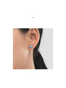 Close-up of S925 silver devil eye stud earrings with turquoise and diamonds on model