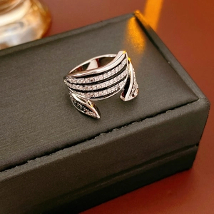 Macro shot of silver multi-layer zircon ring on a grey jewelry gift box