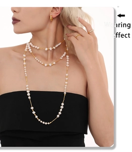 Model wearing a layered vintage freshwater pearl necklace with gold-plated stainless steel
