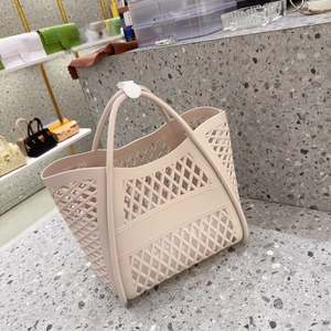 Detail of hollow lattice pattern on beige rubber tote bag with round handles