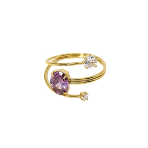 Eleganter goldener Spiralring mit einem großen lila Zirkon und zwei weißen Edelsteinen