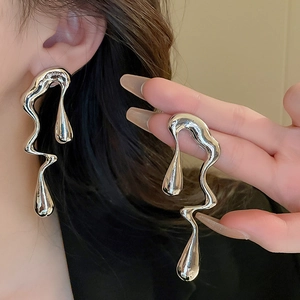 Irregular silver liquid metal lava earrings with a high-shine drip design for women