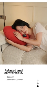 Detail of red heart pillow with Happy Home label on a soft beige sofa set