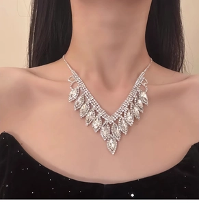 Close-up of elegant V-shaped silver necklace with teardrop rhinestones on model