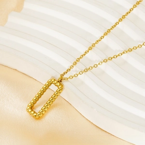 Detail of 18k gold hollow bar pendant with intricate rope texture on fine O-chain necklace
