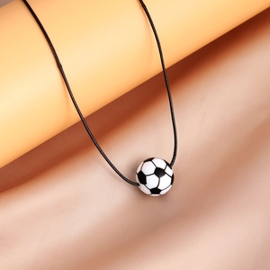 Close-up of a classic black and white soccer ball pendant with a black cord necklace