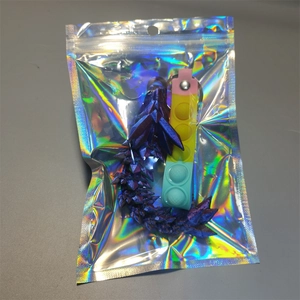 3D printed articulated dragon model in purple-blue gradient inside retail packaging