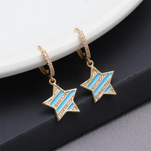 Detail of gold star hoop earrings with blue enamel and sparkling zircon stones