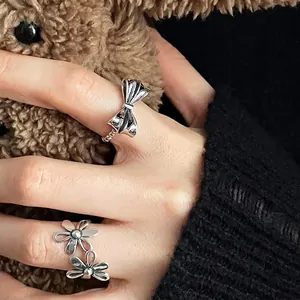 Vintage silver hollow flower and bowknot ring set for women with delicate chain detail