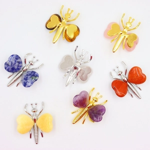 Flat lay showing various natural crystal butterfly ornaments in diverse mineral textures