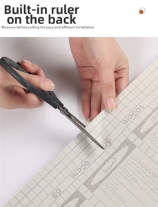 Detail of self-adhesive kitchen wallpaper featuring grid lines for precise cutting