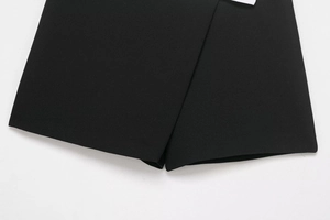 Detailed close-up of contrast stitching on black twill skort hem with sharp texture