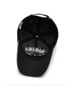 Detailed interior of black cotton baseball cap showing internal seams and embroidered visor