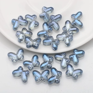 Macro detail of 10x14mm gray-blue butterfly glass beads for DIY jewelry making
