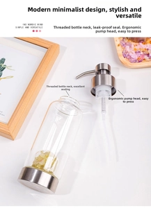 Detail of refillable glass dispenser with threaded neck and silver pump for hand soap