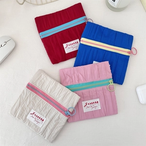 Set of four colorful crinkle fabric cosmetic bags in red, blue, beige, and pink colors
