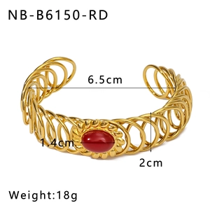 Detailed view of gold stainless steel coil bracelet with red gemstone inlay and size labels