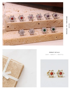 Close-up of small floral stud earrings set with sparkling zircons in various colors