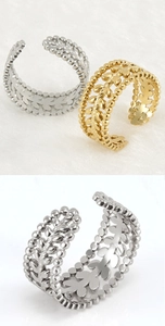 Close-up of gold and silver wheat leaf textured adjustable stainless steel rings
