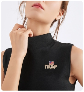 Detail of Trump American flag brooch with gold plating and sparkling rhinestones on a vest
