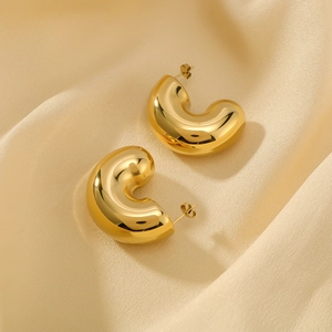 Polished 18K gold plated stainless steel chunky C-shaped hoop earrings on silk
