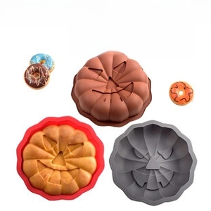 Three-piece pumpkin silicone cake molds in brown, red, and gray for Halloween baking