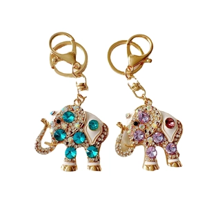 Golden elephant keychains with blue and purple rhinestones and white enamel detailing