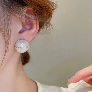 Elegant semi-round drip oil stud earrings with gold chain detail on model