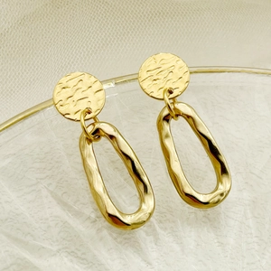 Minimalist gold geometric animal earrings with hammered texture on clear glass