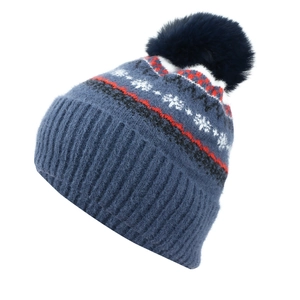 Detail of navy knit beanie with plush faux fur pompom and festive snowflake patterns