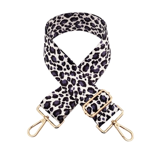 Detail of leopard print wide strap with golden metal buckle and lobster clasp
