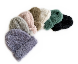 Flat lay of soft plush knit beanies in multiple colors including purple, grey, and black