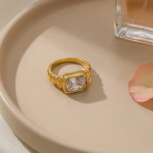 Detailed shot of golden twisted texture ring featuring a large rectangular zircon stone