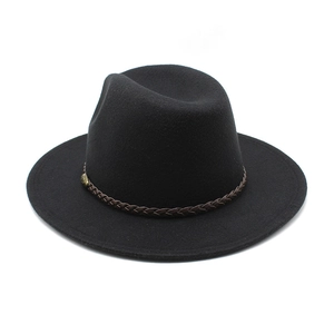 Detail of black fedora hat featuring a brown braided leather band and vintage buckle