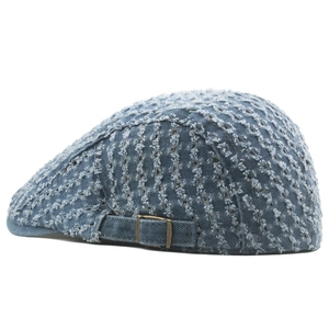 Adjustable light blue distressed denim flat cap with ripped mesh texture and retro style