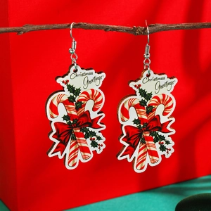 Detailed view of candy cane Christmas earrings with bow and holly leaf accents