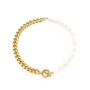 Elegant gold Cuban chain and white pearl necklace with OT toggle clasp on white background