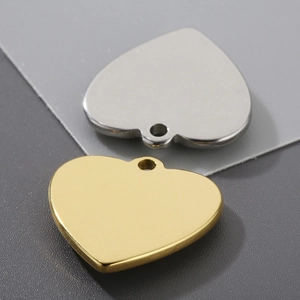 Macro shot of gold and silver heart pendants in polished stainless steel for DIY jewelry