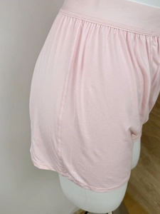 Close-up of pink soft knit shorts with refined stitching on a mannequin