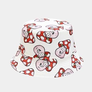 Detail of white bucket hat featuring cute cartoon mushroom prints and fine stitching
