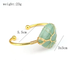 Detail of gold wire wrapped bangle with a green raw stone showing size 5.5cm and 23g weight