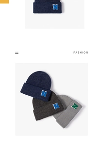 Detail of ribbed knit beanies in navy and grey featuring embroidered letter N logo