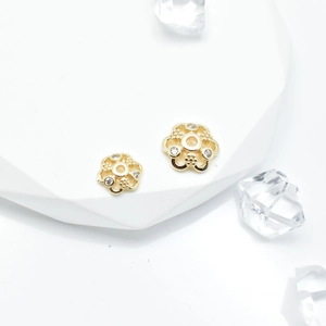 Macro shot of 18k gold plated snowflake spacer bead with sparkling zircon crystals