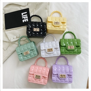 Close-up of mini PVC jelly bags in multiple colors with quilted patterns and gold clasps