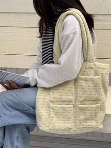 Chic yellow plush tote bag with multi-colored buttons and four front pockets