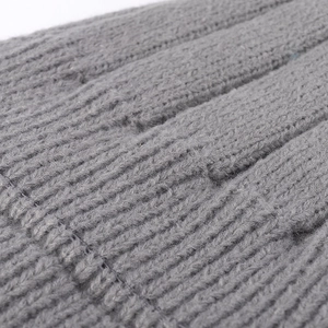 Close-up of grey ribbed knit beanie showing high-quality warm fabric texture and detail