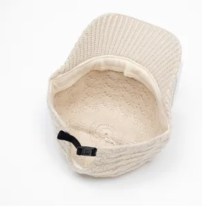 Detail view of the warm knit baseball cap interior with stitching and adjustable strap