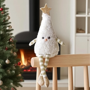 Detail of plush Christmas tree doll with golden star and striped legs on wooden shelf