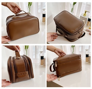 Detail view of brown PU leather makeup bag with gold zippers and multi-layer storage