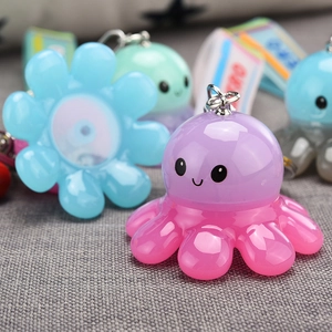 Macro shot of colorful octopus acrylic keychains with glowing light effect and key rings